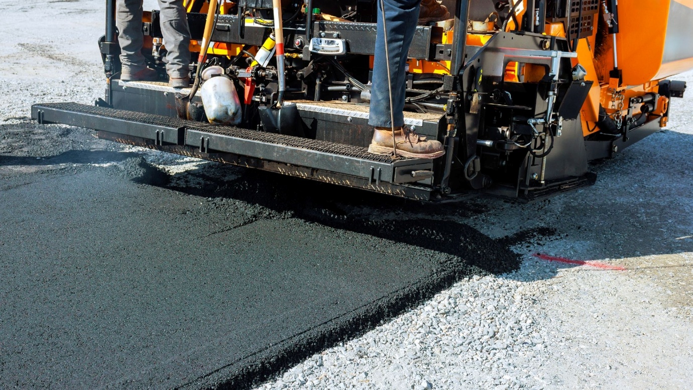 Asphalt paver laying a fresh pavement surface